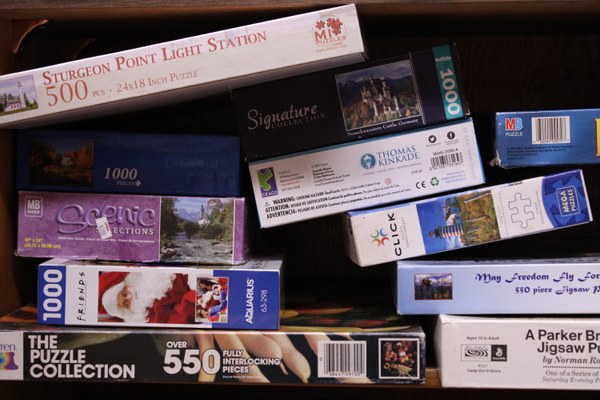 Close up of puzzles stacked on a shelf